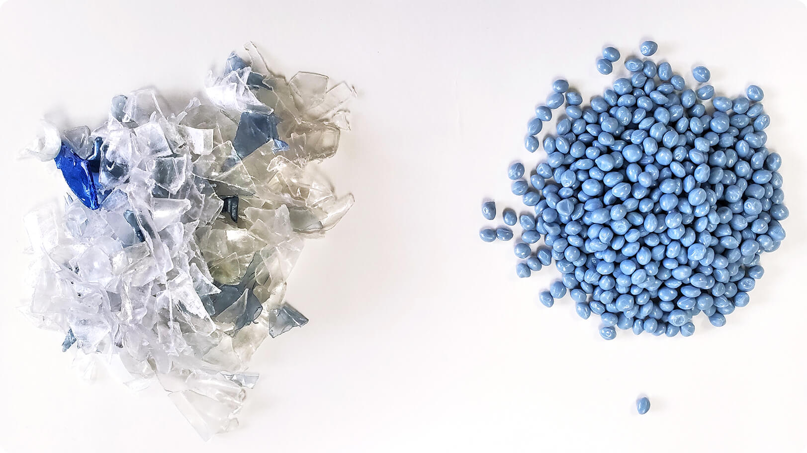 Recycled plastic in 2 forms. Blue pellets and flakes